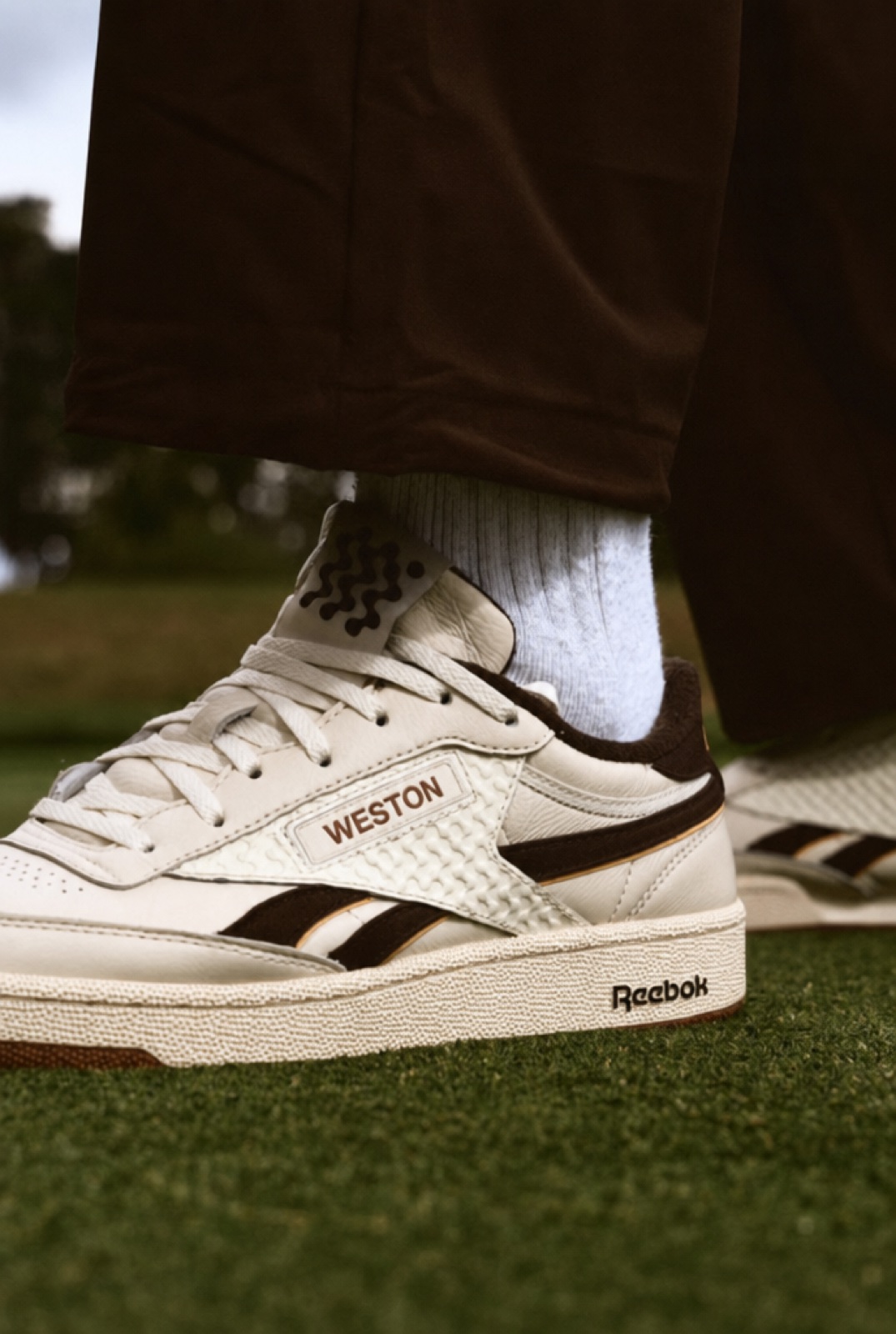The Court Golf Shoe in Espresso, laced on the fairway.